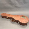 Vintage brown Gibson USA guitar hard case with metal latches and worn leather handle on gray background