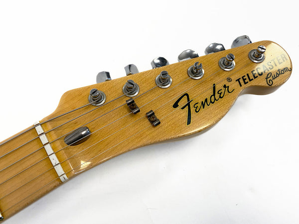 Close-up of Fender Telecaster Custom guitar headstock with tuning pegs and strings on white background