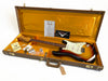 Vintage Fender Stratocaster electric guitar in sunburst finish with original brown hard case and accessories including certificate of authenticity and Fender instructional materials