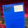 Gibson USA guitar warranty certificate card for model LPSH5CH with serial number 92896399 on red plush background