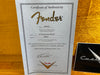 Fender Certificate of Authenticity for 62 Stratocaster Relic guitar with serial number R35953 dated 06/06/07 from Fender Custom Shop in Corona California on a wooden background
