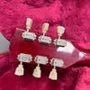 Close-up of vintage red guitar headstock with six vintage tuning pegs on plush pink guitar case lining