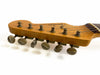 Close-up of vintage Fender Stratocaster guitar headstock with six tuning pegs and strings against white background