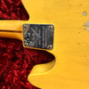 Close-up of Fender Custom Shop 70th Anniversary Telecaster neck plate on yellow relic finish guitar body with red plush case lining background