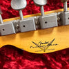 Close-up of Fender Custom Shop Limited Edition guitar headstock with vintage tuning machines on red plush background