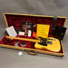 Vintage Fender Telecaster electric guitar with maple neck and black pickguard in open tweed hard case with red plush interior, including Fender certificate of authenticity, custom guitar design guide, and other Fender documentation and accessories.