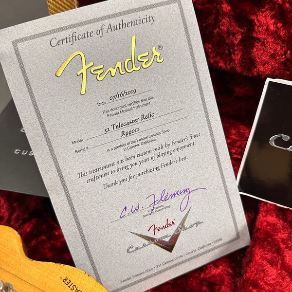 Fender Certificate of Authenticity for 52 Telecaster Relic guitar dated 07/16/2019 with serial number R09011 on red plush guitar case interior background