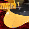 Close-up of vintage electric guitar body and maple fretboard with black pickguard, showing wear and finish checking on yellow finish over red velvet background