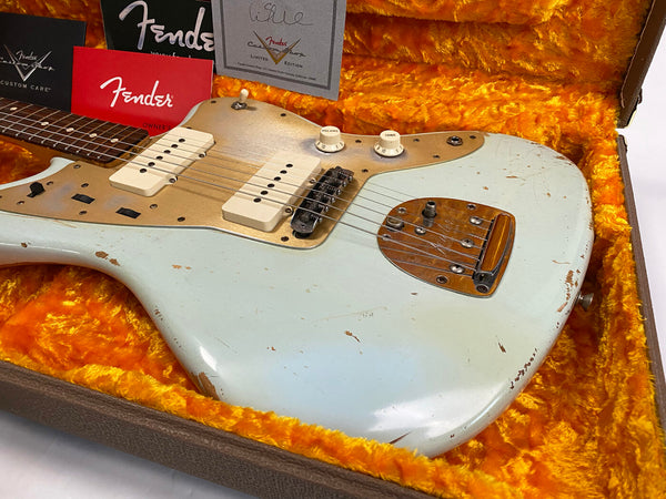 Fender vintage electric guitar with cream finish, white P90 pickups, and gold pickguard in orange plush-lined case with Fender documentation