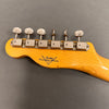 Fender Custom Shop vintage guitar headstock with six vintage tuners on maple neck against gray background