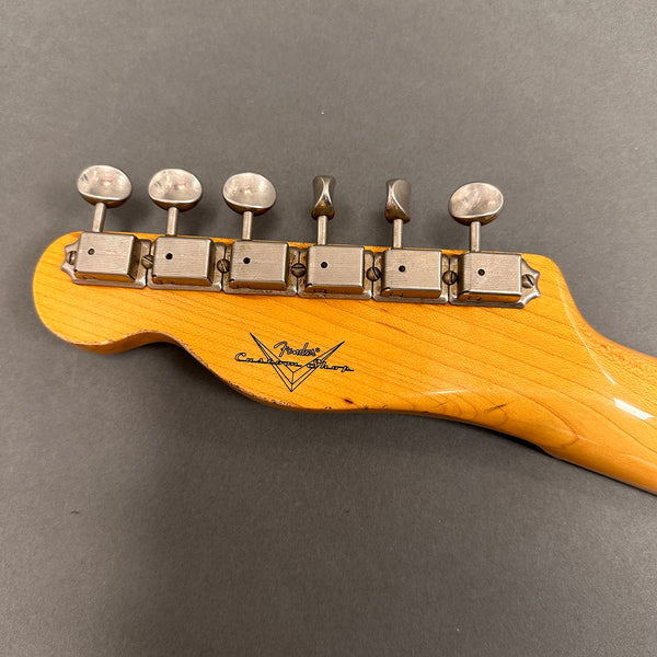 Fender Custom Shop vintage guitar headstock with six vintage tuners on maple neck against gray background