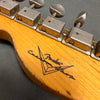 Close-up of vintage Fender Custom Shop guitar headstock with tuning pegs and worn wood finish