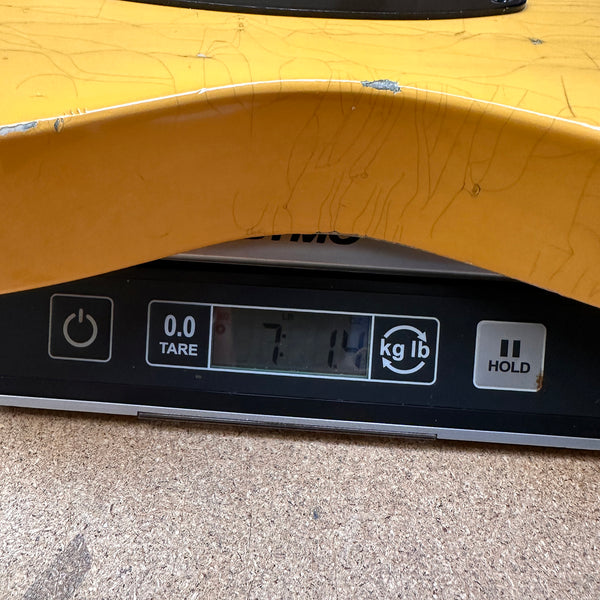 Close-up of a guitar body measuring 7 pounds 14 ounces on a digital scale, showing weight for guitar listing at Coffee House Guitars.