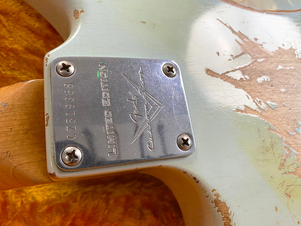 Close-up of Fender Custom Shop Limited Edition neck plate on a worn vintage electric guitar body with chipped paint and aged wood finish