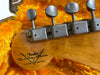Close-up of Fender Custom Shop Limited Edition guitar headstock with vintage Kluson tuning pegs in orange plush guitar case interior