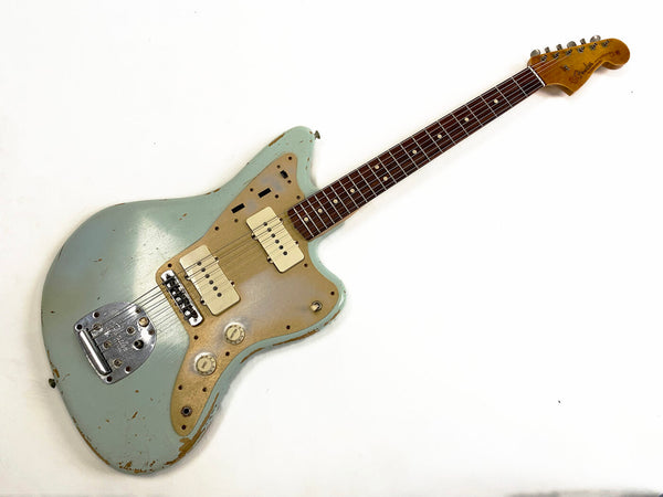 Vintage Fender electric guitar with worn light blue finish and gold pickguard, rosewood fretboard, and two cream-colored pickups on white background