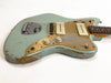 Vintage worn light blue electric guitar with two white pickups, cream tone and volume knobs, and a gold pickguard on white background