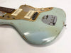 Vintage Fender electric guitar with faded blue finish and gold pickguard, two cream single-coil pickups, volume and tone knobs, and aged chrome bridge on white background