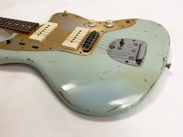 Vintage Fender electric guitar with faded blue finish and gold pickguard, two cream single-coil pickups, volume and tone knobs, and aged chrome bridge on white background