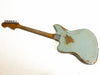Vintage worn light blue electric guitar back view with maple neck and metal tuning pegs, showing distressed finish and wood patches