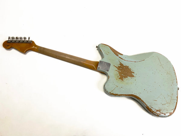 Vintage worn light blue electric guitar back view with maple neck and metal tuning pegs, showing distressed finish and wood patches