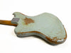 Back of vintage Fender electric guitar body with worn light blue paint and exposed wood on white background