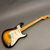 Fender Stratocaster electric guitar with sunburst finish and maple neck on gray background