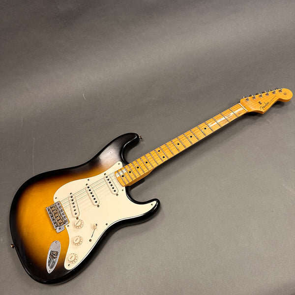 Fender Stratocaster electric guitar with sunburst finish and maple neck on gray background
