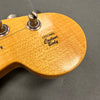 Close-up of guitar headstock with vintage tuning pegs and "Original Contour Body" decal on natural wood finish
