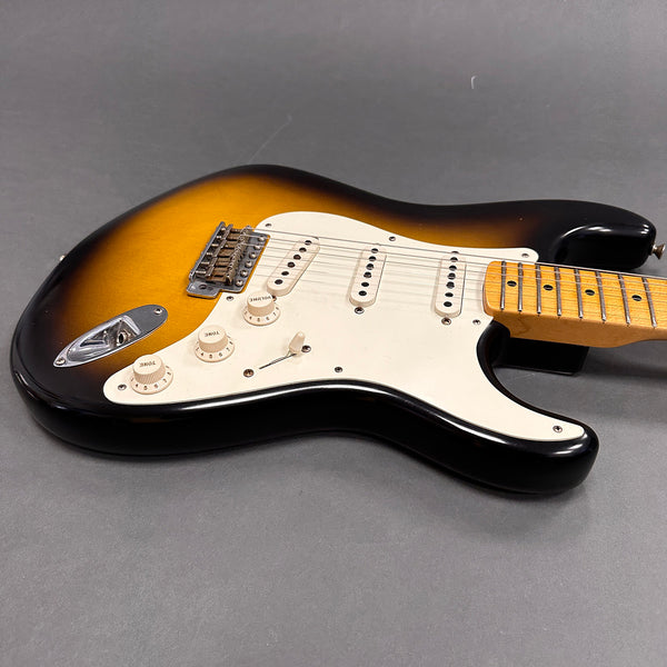 Sunburst electric guitar with maple neck and white pickguard on gray background