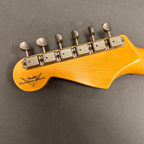Close-up of Fender Custom Shop vintage-style guitar headstock tuners with six metal tuning pegs on natural wood finish guitar neck