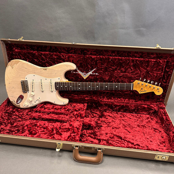 Vintage Fender Stratocaster electric guitar with worn white finish in open brown hard case with red plush interior