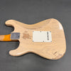 Vintage worn beige electric guitar back with visible wood grain and cracked finish, showing signs of heavy use and aging, featuring a metal neck plate and white plastic cavity cover.