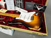 Fender Stratocaster relic electric guitar in sunburst finish with maple neck and vintage wear, displayed in tan tweed hard case with red plush interior, Fender Custom Shop certificate and paperwork.