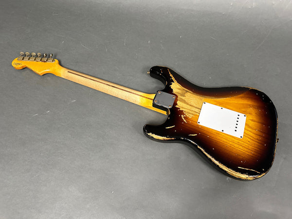 Vintage worn sunburst electric guitar back with maple neck and tuning pegs on gray background
