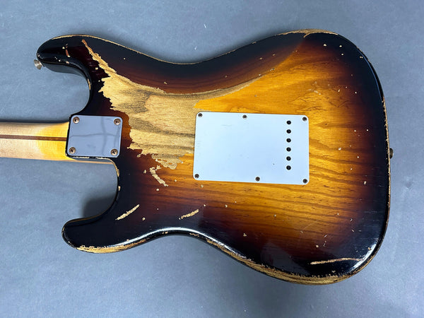 Vintage sunburst electric guitar body with worn and chipped paint showing natural wood grain, white backplate, and maple neck heel.