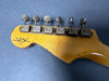 Vintage Fender Custom Shop electric guitar headstock with six tuning pegs on natural wood finish against dark background