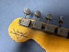Close-up of vintage Fender Custom Shop guitar headstock with aged tuning pegs and yellow finish