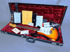 Fender Stratocaster electric guitar in sunburst finish with white pickguard inside black hardshell case lined with red plush, surrounded by Fender certificate of authenticity, warranty card, paperwork, and accessories for sale at Coffee House Guitars.