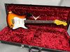 Fender Custom Shop 1957 Stratocaster electric guitar in sunburst finish resting in red velvet-lined hard case