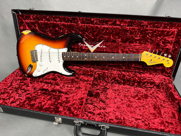 Fender Custom Shop 1957 Stratocaster electric guitar in sunburst finish resting in red velvet-lined hard case