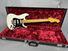 Vintage Fender Stratocaster electric guitar with white body and maple neck in black hard case with red velvet interior