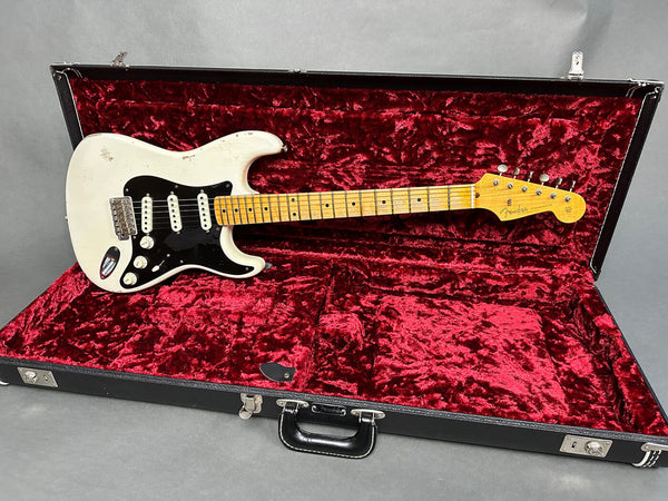 Vintage Fender Stratocaster electric guitar with white body and maple neck in black hard case with red velvet interior