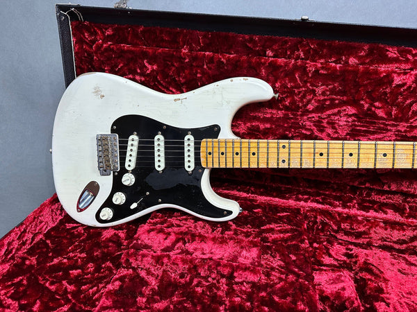 Vintage white electric guitar with black pickguard and maple neck in red velvet lined case