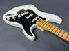 Vintage white electric guitar with black pickguard and maple fretboard showing wear and aging against gray background