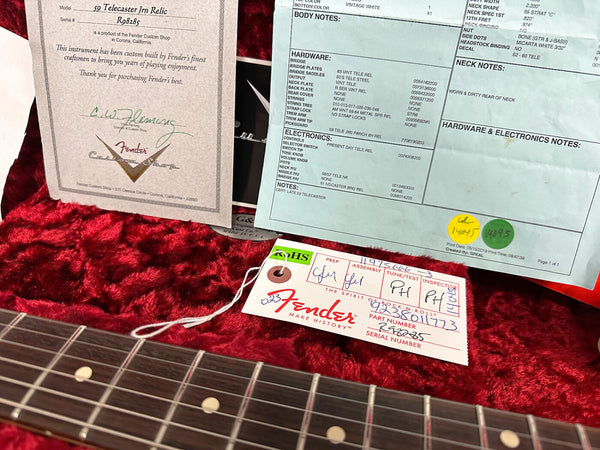 Fender Custom Shop certificate and tag for 59 Telecaster Jm Relic guitar with serial number R08285 on red plush case lining, close-up of guitar neck fretboard.
