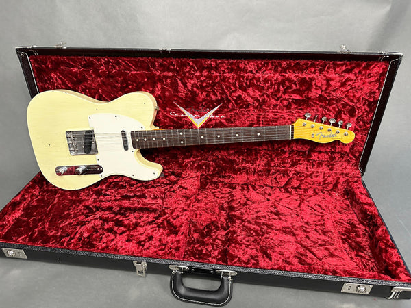 Vintage Fender Telecaster electric guitar in blonde finish with rosewood fretboard, displayed in black hard case with red plush interior lining