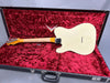 Vintage cream solid body electric guitar with maple neck in open black hard case with red velvet interior lining