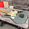 Fender electric guitar with maple neck and light blue body in a plush guitar case with Fender certificate of authenticity and tags