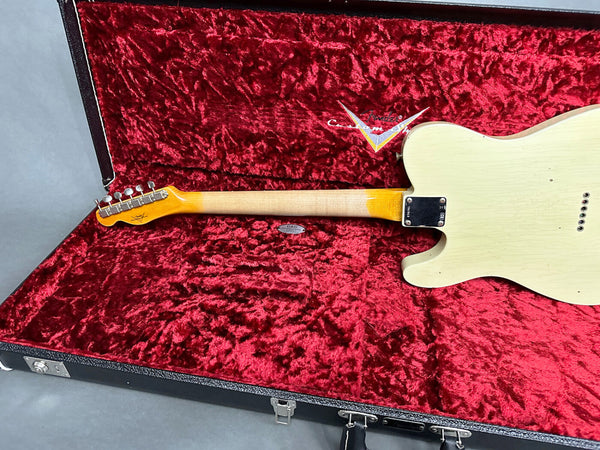 Back view of white vintage electric guitar with maple neck inside red plush-lined black hard case, showing guitar neck, tuning pegs, and case interior logo